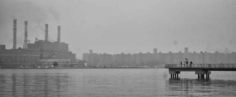 People on a pier on a grey day.