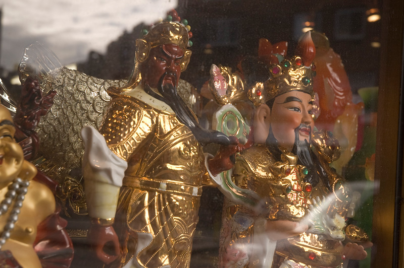Chinese figurines in a shop window.