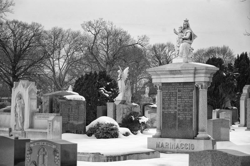 A family tombstone, with Madonna and child at the top.