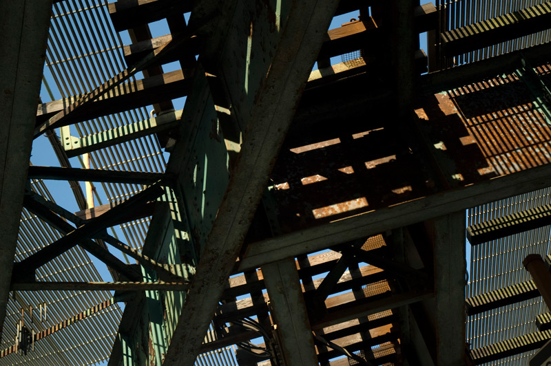 Elevated train tracks in silhouette.