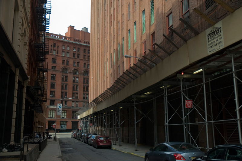 An alley, with scaffolding.