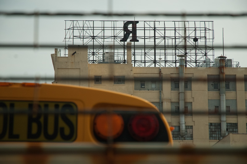 A sign above a building, with only an 'R' left.