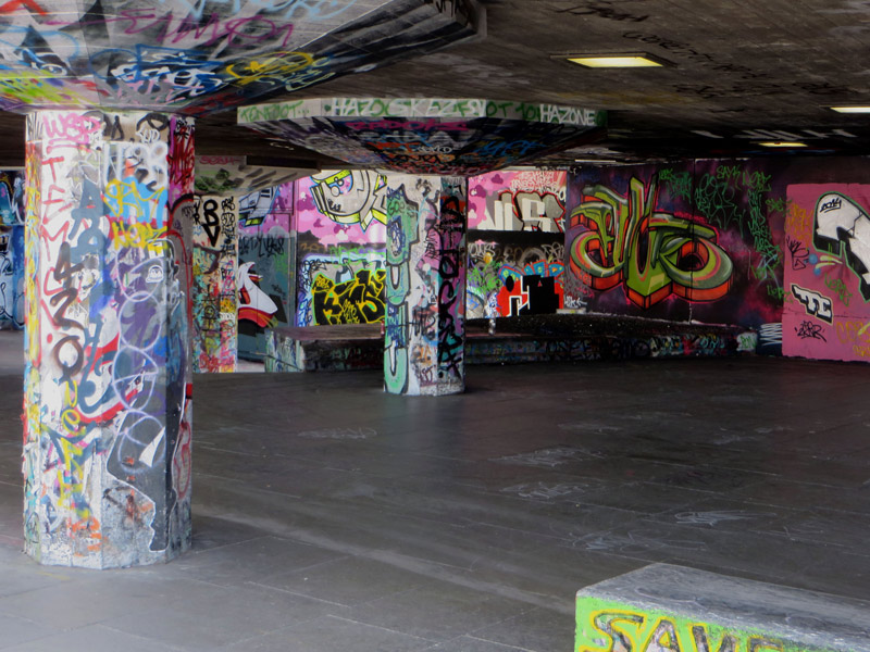 Pillars and walls adorned with graffiti.