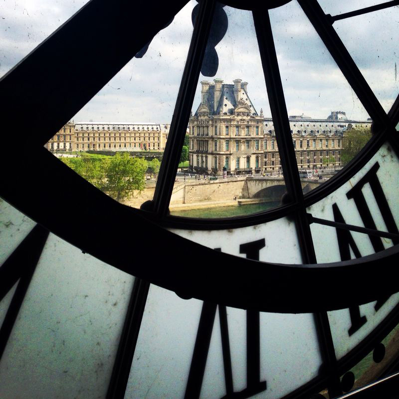 A building, seen through a clock face.