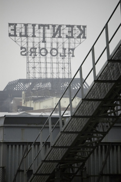 The Kentile Floors sign, behind industrial buildings.