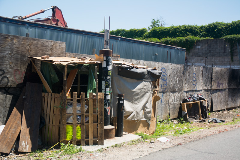 A shack against the side of a building.