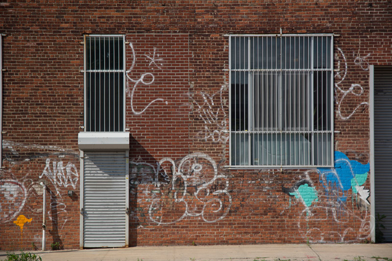 Windows with gates, a brick building.