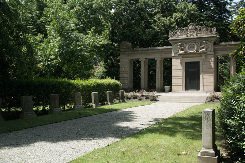 An ornate mausoleum at the head of a walkway.