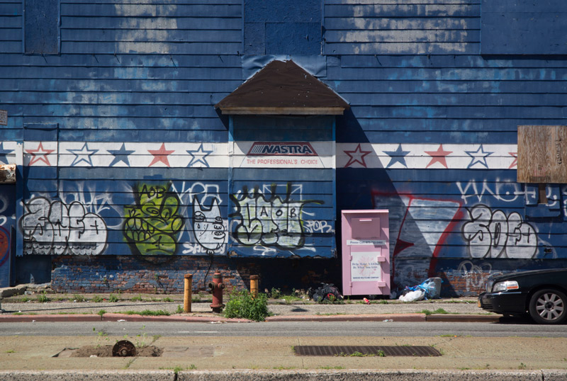 An old abandoned car parts store, with graffiti.