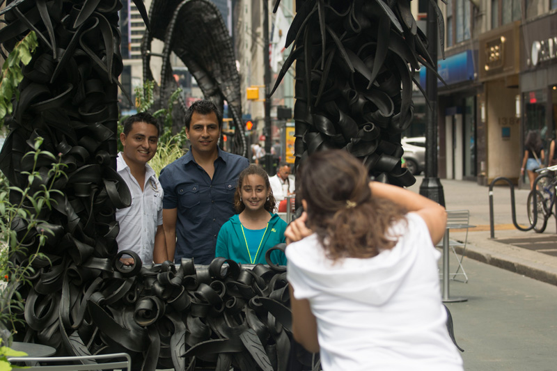 A family stands in a frame made of old tire rubber.