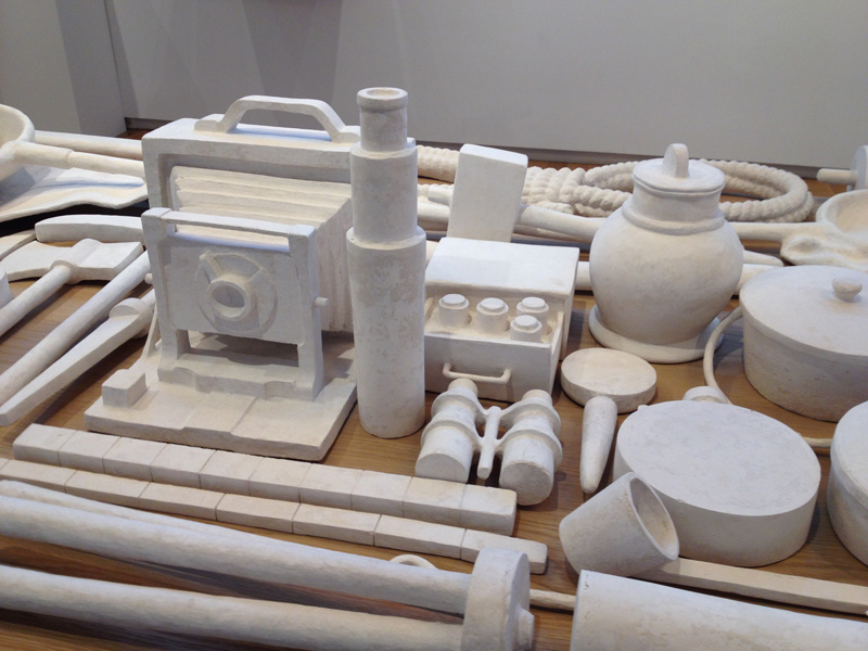 Sculpted white objects on a table.