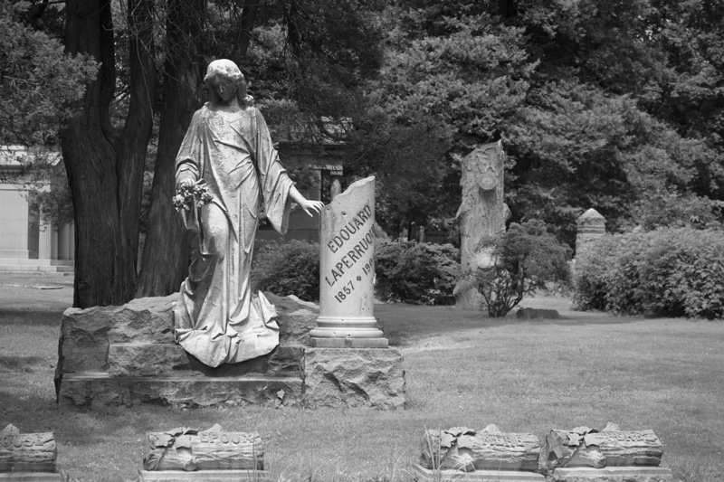 A gravesite with a broken pillar.
