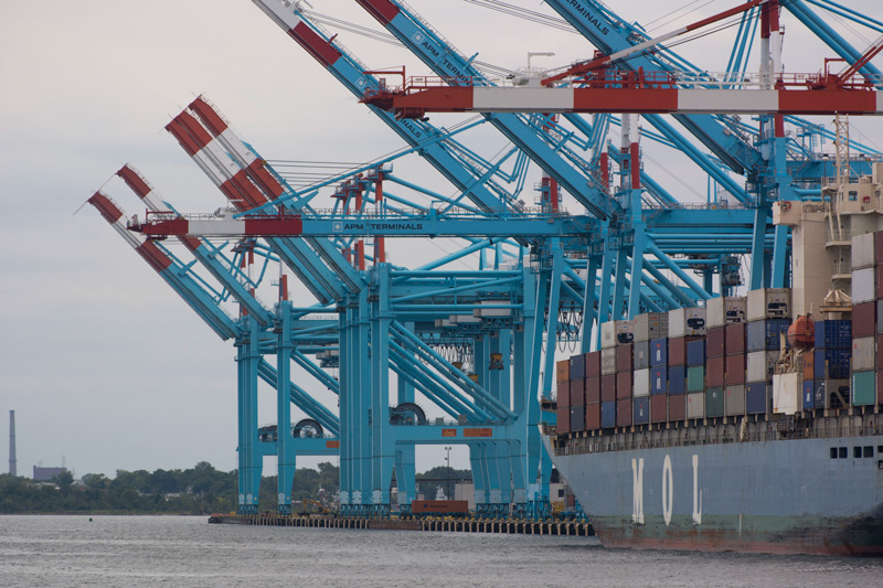 Loading cranes and a container ship.