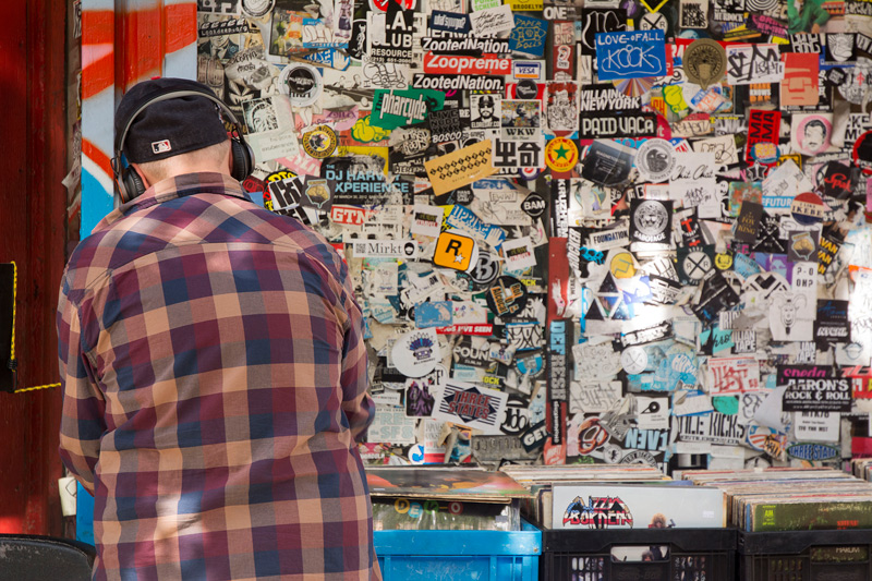 A man going through bins of vinyl at a used record store