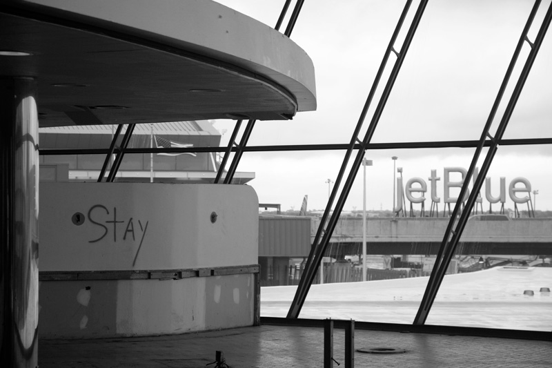 'Stay' is painted on a counter in an empty airline terminal