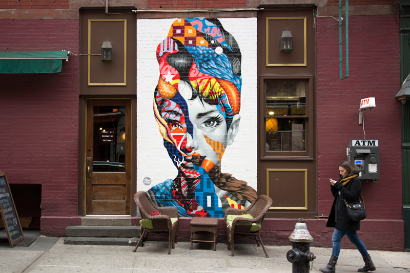 An Italian mural by an outside table.