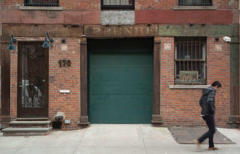 An old garage door, with portions of 'Oppenheim' visible overhead.