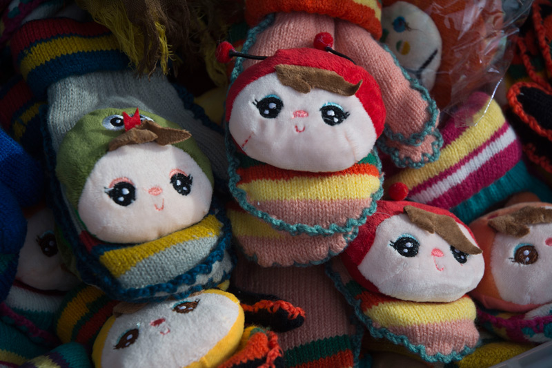 Children's mittens, decorated with faces.