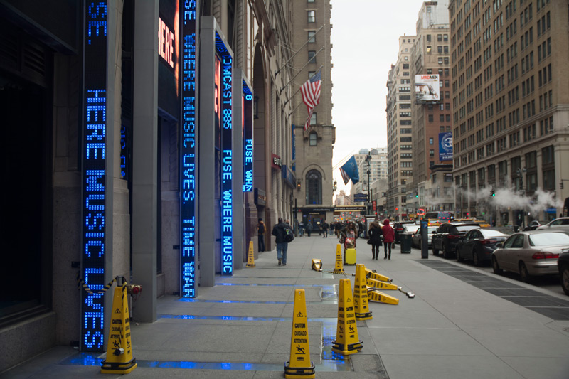 Electric signs with feeds of words in blue.