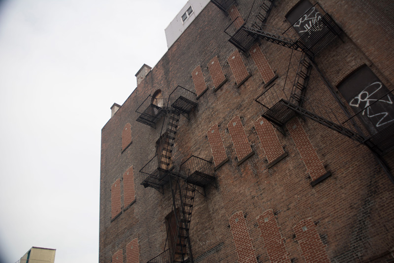 A building, with bricked-in windows.