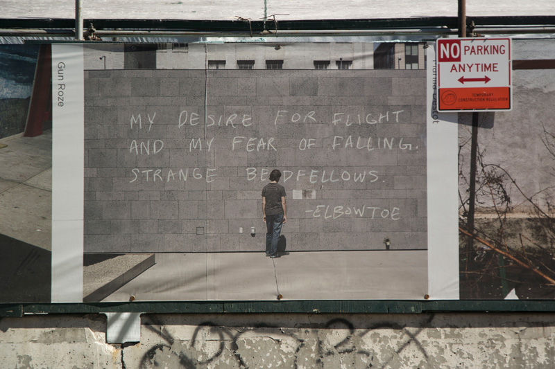 A graffiti artist has written on a wall in a photo on a fence.