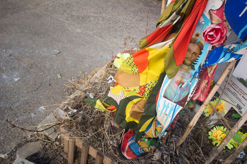 An image of Jesus, draped in colored fabric.