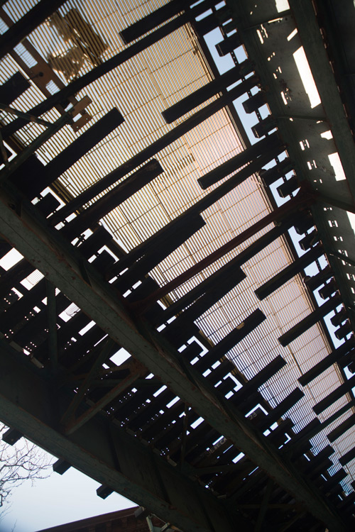 Elevated train tracks in silhouette.