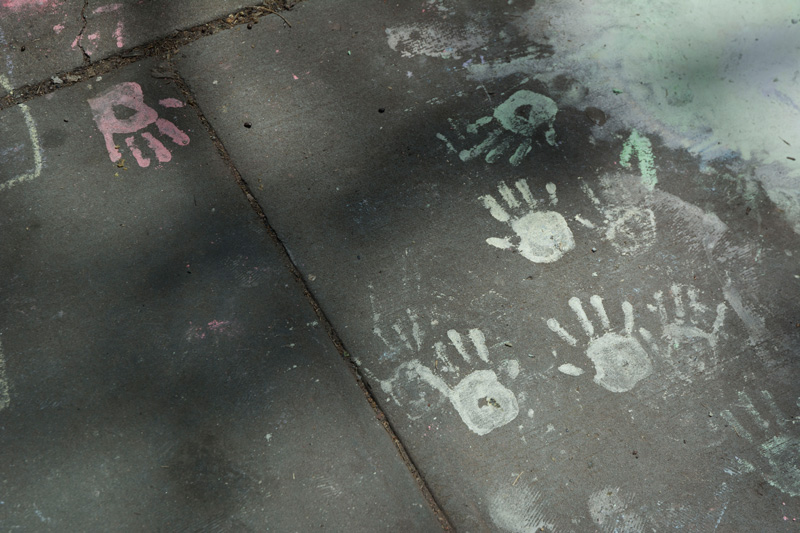 Children's handprints on a sidewalk