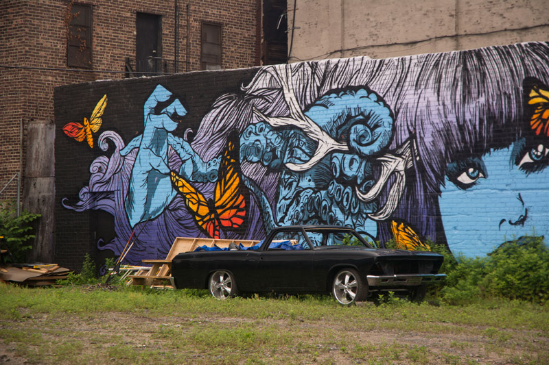 A small truck, in front of a mural featuring Zooey Deschanel.