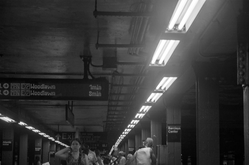 A sign on a subway platform announces the next train for Woodlawn.