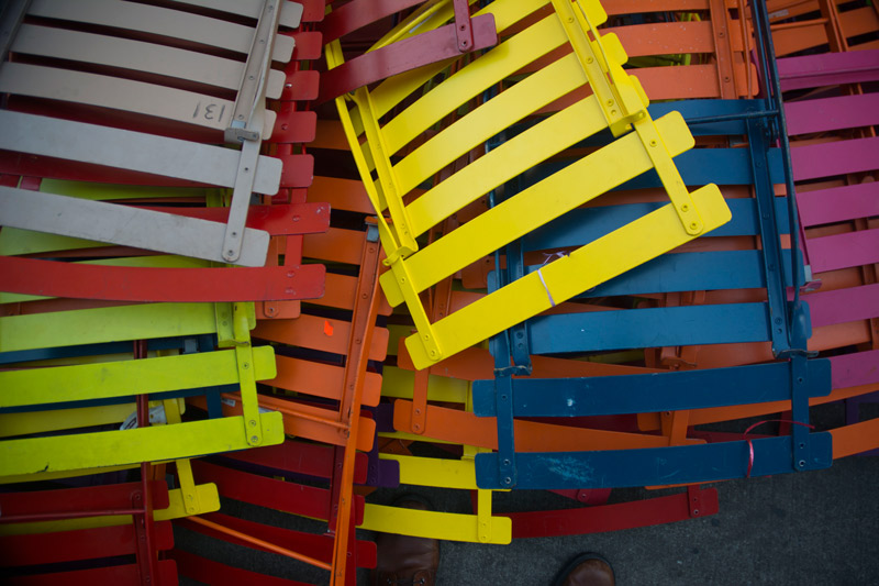 Colorful folding chairs, folded flat.