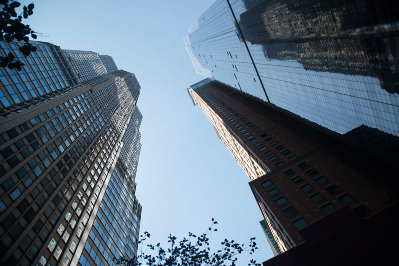 Looking up at the sky, through a canyon of skyscrapers.