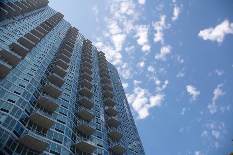 A high rise apartment building with balconies.