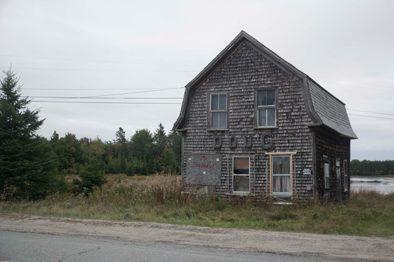 An abandoned house, with the name 'Doug' in big letters on its front.