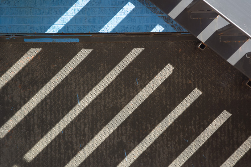 Diagonal shadows on a wall.