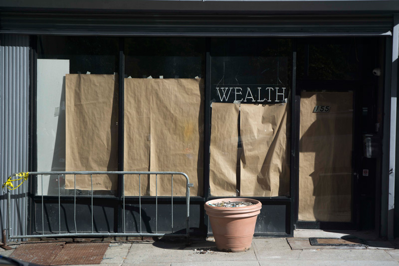 A storefront in preparation, named 'Wealth.'