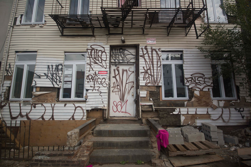 An abandoned house, covered in graffiti.