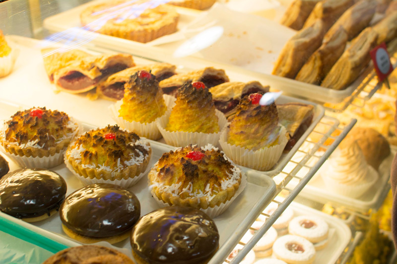 Pastries in a refrigerated display case.
