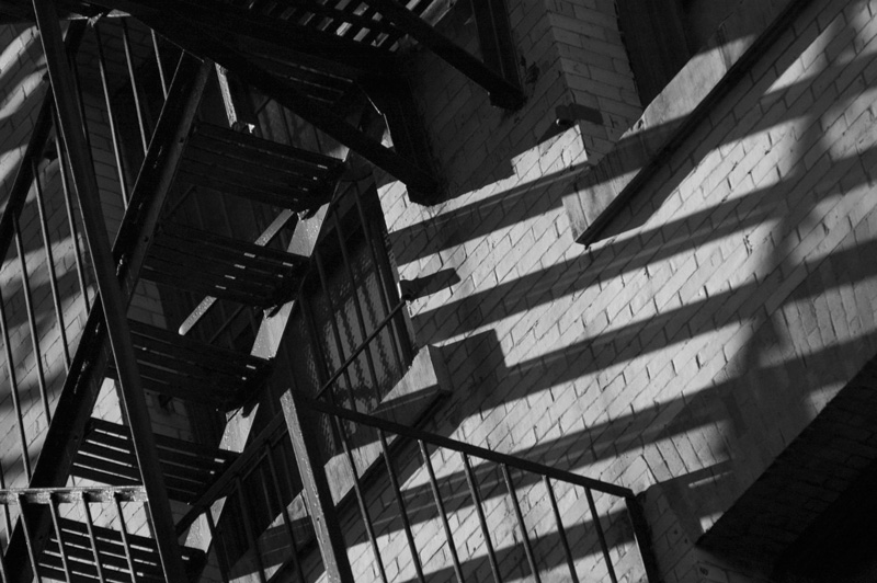 Wild angles of a fire escape and its shadows.