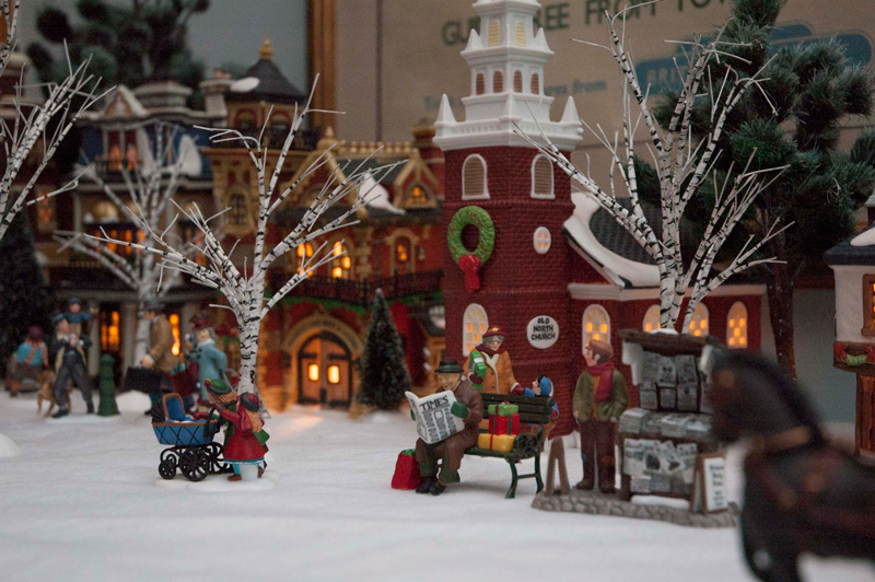 A Christmas village of porcelain figurines.