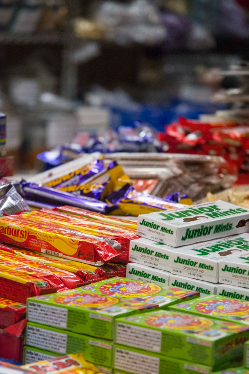 Boxes of 'Junior Mints' on a table in a candy store.