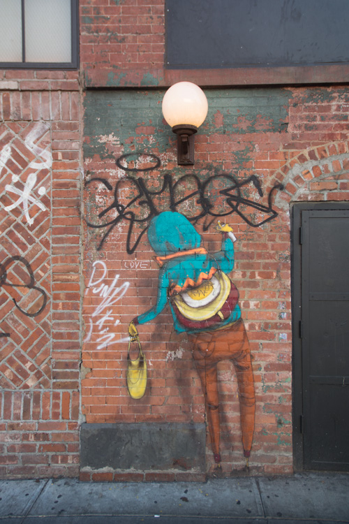 Street art by Os Gemeos shows someone painting street art.