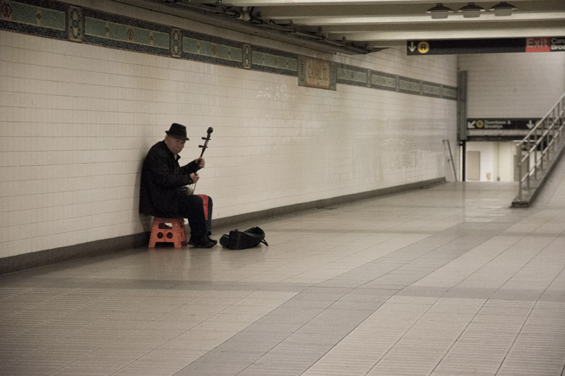 An Erhu player -- the two-stringed Chinese violin -- in an empty passage in a subway.