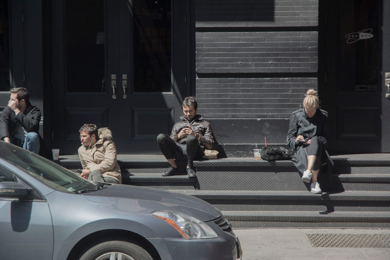 People on steps, separated by distance and what they pay attention to.