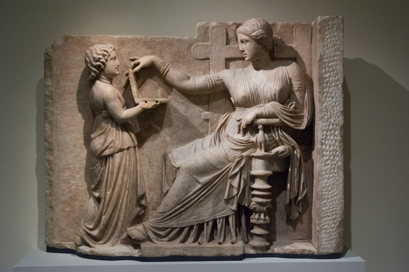An ancient relief, showing a servant waiting on his lady.