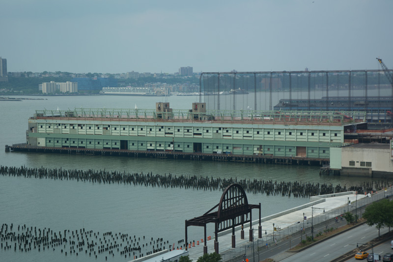 Pilings from former piers extend out into the Hudson River.