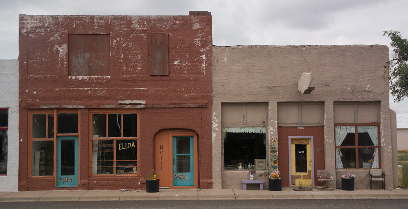 Two old, quiet storefronts on a street.