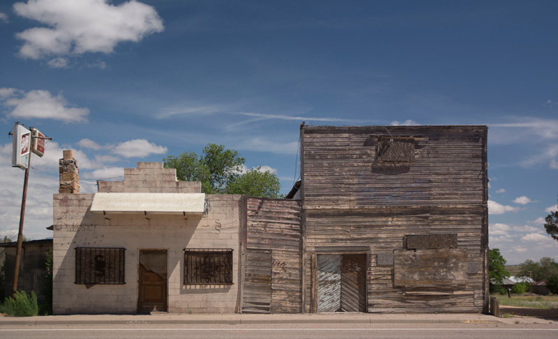 Two vacanat buildings suggest a dead town.