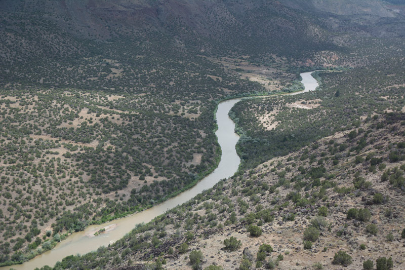 The Rio Grande River river snakes through a desert valley.