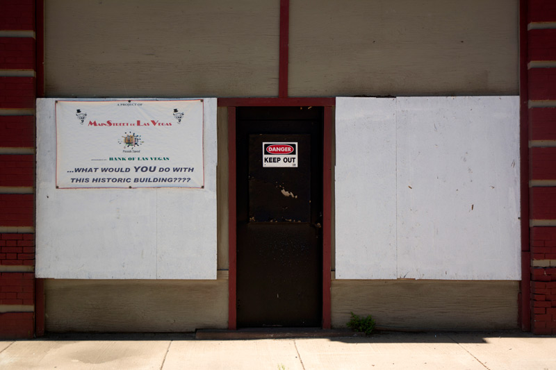 One sign on an abandoned building wants you to imagine its possibilities; another warns you off.